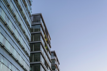 modern urban architecture, glass facades in front of blue sky
