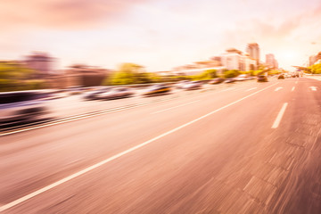 Car driving on road at sunset, motion blur