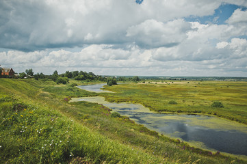 Marshy river flows through the field 5120.