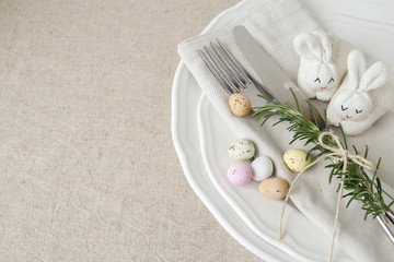 Easter table setting with Easter eggs and bunnies for lunch or dinner