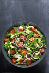 Salad with arugula, cheese, tomato and red onion