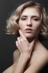 Naklejka premium woman with short haircut and hand near the face