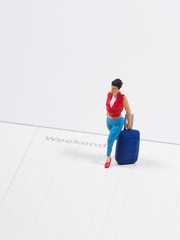 Miniature - Women traveler on the calendar, Weekend trip concept