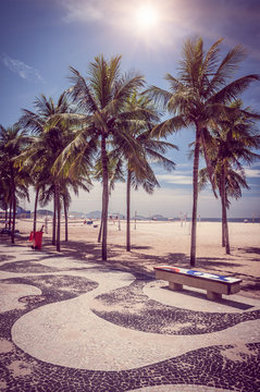 Copacabana with palms and mosaic of sidewalk in Rio de Janeiro. Brazil