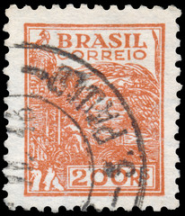 Stamp printed in the Brazil shows Wheat harvesting machinery