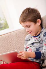 boy playing with digital tablet