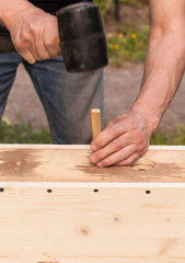 Birdhouse made of wood is under construction, carpenter