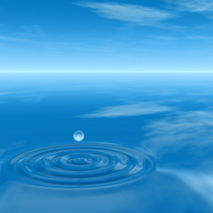 Conceptual blue liquid drop falling in water