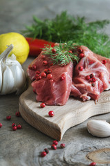 Raw lamb meat with spices on wood board over old wooden backgrou