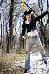 Man in clown hat jumping in the woods