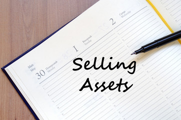 Selling assets write on notebook