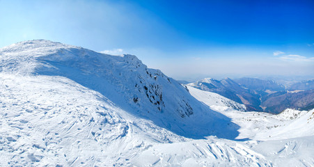 Obraz premium Winter snow covered mountain peaks in Europe. Great place for winter sports.