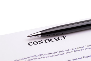 Close-up of pen on contract 