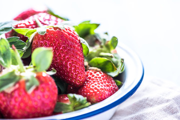 Fresh strawberry in enamel rustic bowl