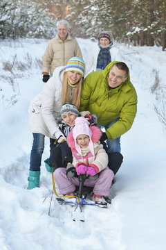 Family  In Winter With  Snowmobile