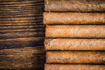 Hand rolled cigars on wooden table