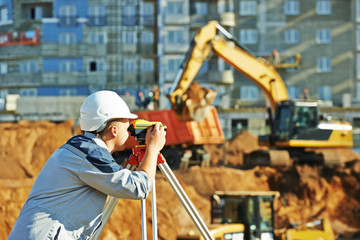 Surveyor working with theodolite equipment