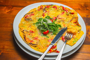 Scrambled eggs with vegetables served on a white plate