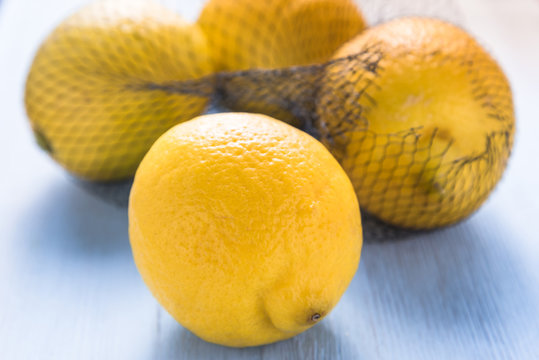 Fresh lemons in shopping net or bag