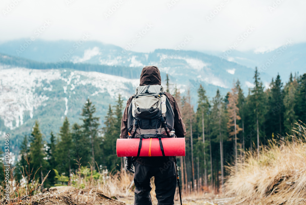 Wall mural caucasian male hiking in mountains