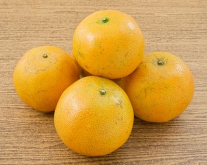 Five Fresh Oranges on A Wooden Table