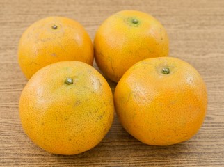 Four Fresh Oranges on A Wooden Board