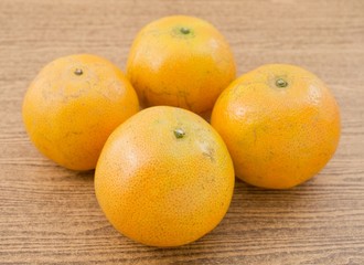 Four Fresh Oranges on A Wooden Table