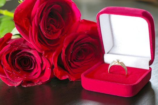 Red roses and wedding ring