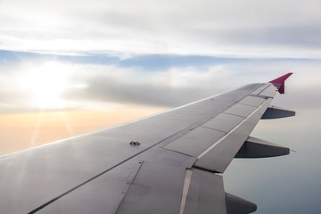 Naklejka na ściany i meble Clouds and sky as seen through window of an aircraft