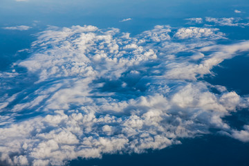 Clouds and sky as seen through window of an aircraft