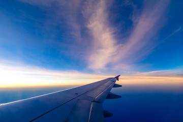 Naklejka na ściany i meble Clouds and sky as seen through window of an aircraft