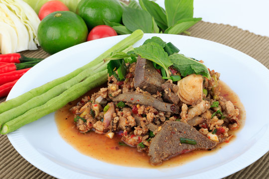 Thai ground pork salad, Spicy minced pork and pork liver salad (Larb Mu) on brown cloth background