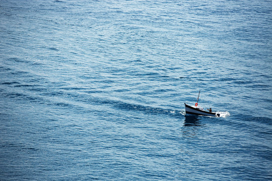 Fisherman and fishing boat in the sea near Monaco