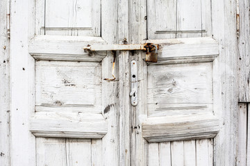 part of the old locked wooden door painted in white
