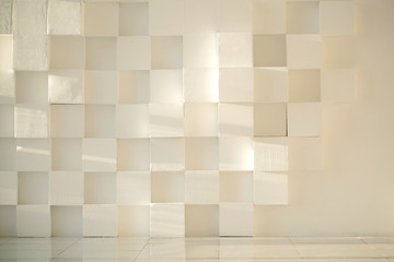 White painted concrete wall made of cubes with tiled floor