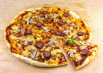 handmade pizza with salami, mussels and mushrooms, fried pieces
