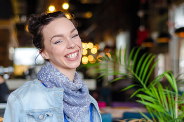 Woman with jeans jacket sitting in cafe