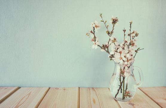 spring bouquet of flowers on the wooden table with mint background. vintage filtered and toned

