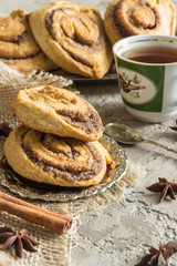 Rolls puff pastry with cinnamon and sugar, tea Cup