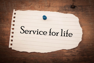 Service for life concept on note paper and wood 