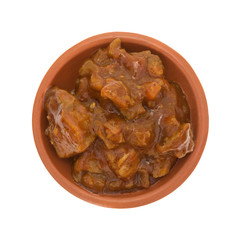 Braised beef in a small bowl on a white background