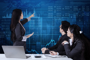 Female worker presents financial statistics