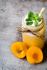 Plum smoothie, on the grey  background.