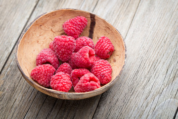 Buckthorn berry basket on wooden background.