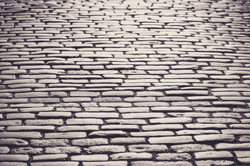 Cobblestones shining during sunset in monochrome.