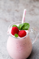 Raspberry milk shake with mint decor.