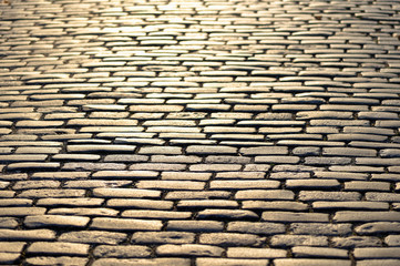 Cobblestones shining in yellow during sunset