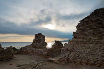 Beach with ruins of old roman city of Nora, Sardinia, Italy