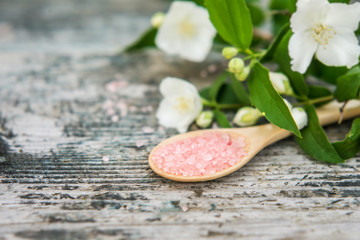 Spa and wellness setting with sea salt, oil essence, jasmin flow