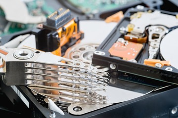Broken and disassembled head and other parts of a hard disk drives.